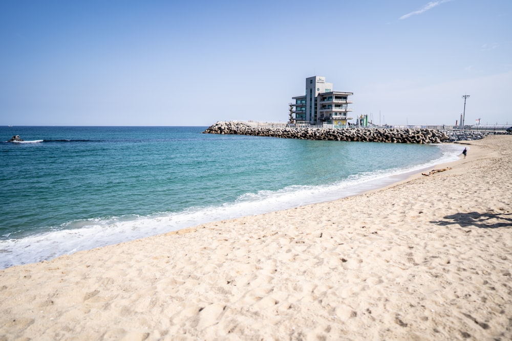 a beach with a building in the background