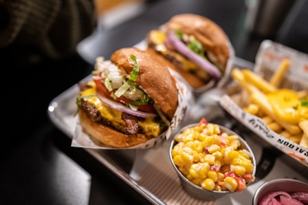 a couple of burgers with fries