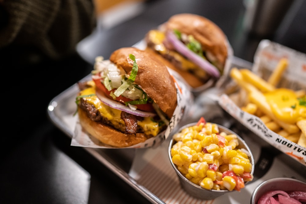 a couple of burgers with fries