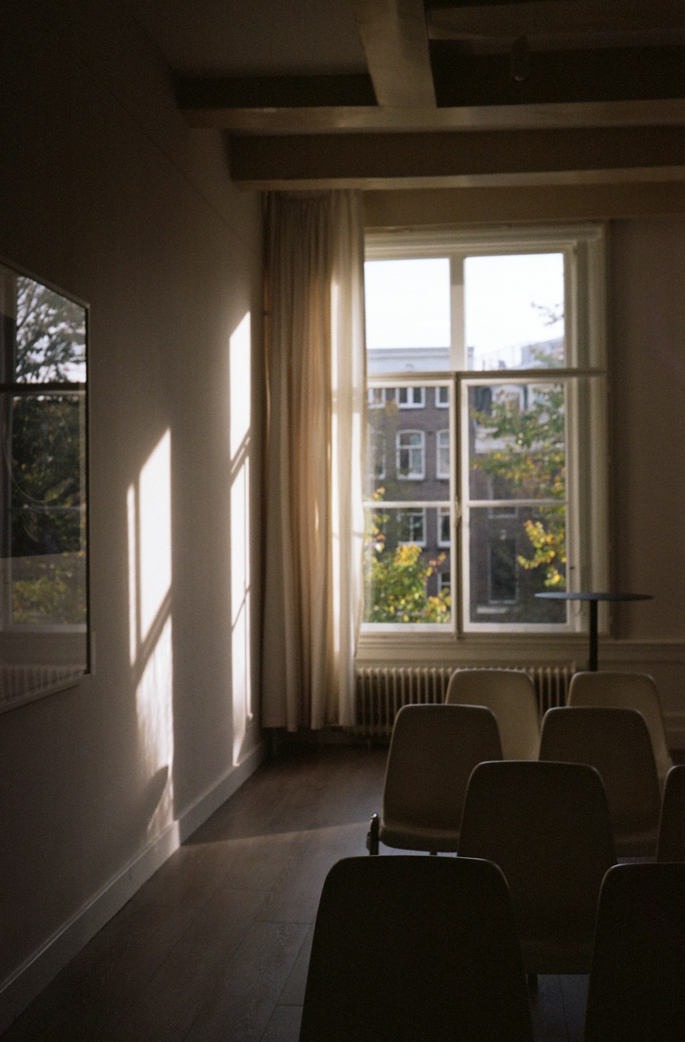 a room with chairs and a window