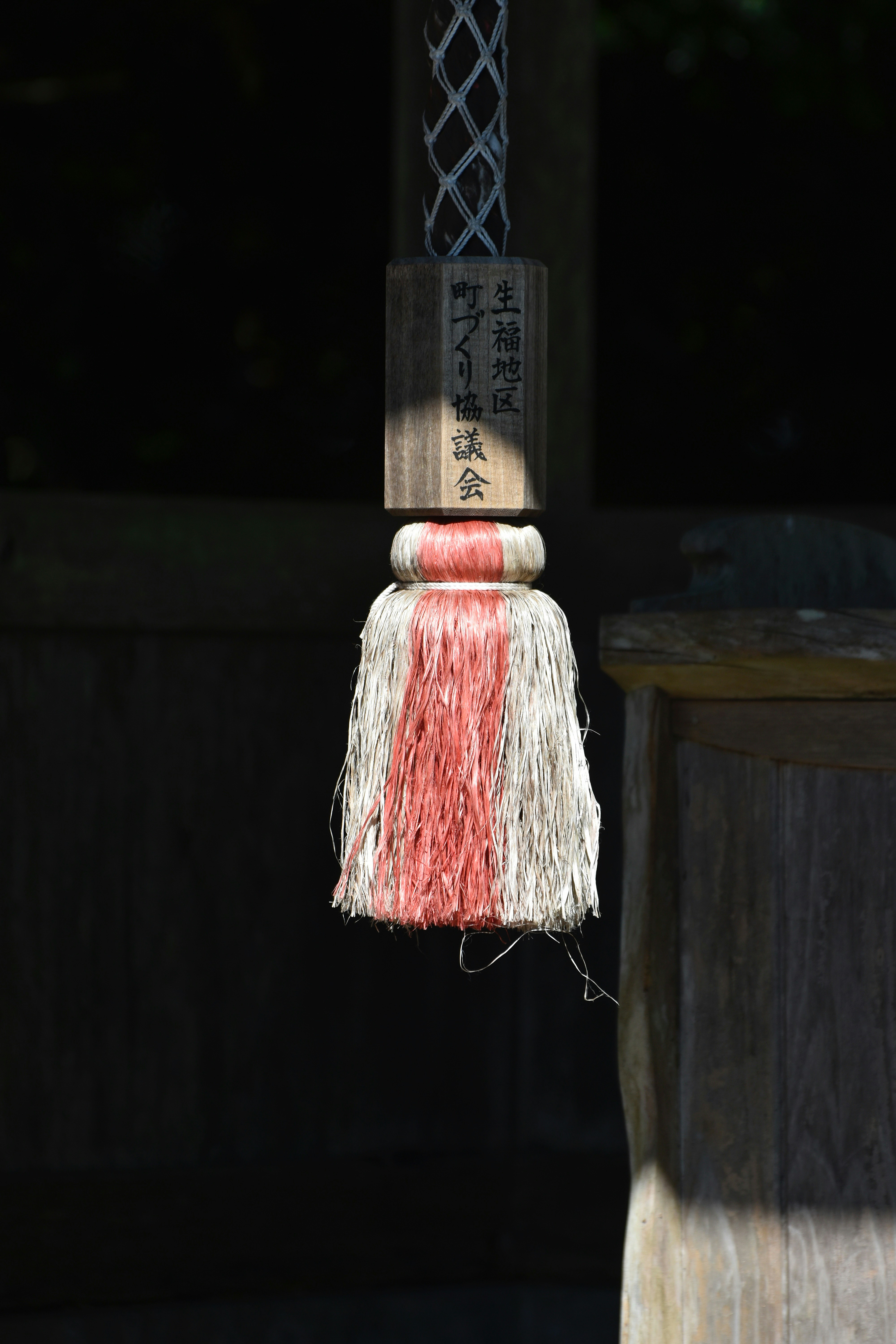 a red and white cylindrical object with a white label on it