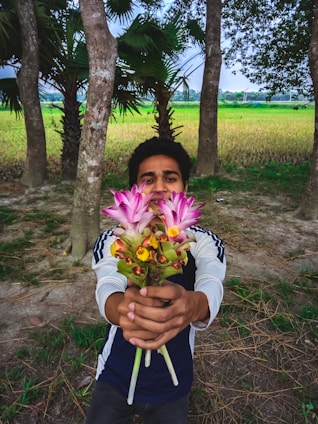A delivery person handing over a beautiful bouquet of flowers to a smiling customer in a Parisian street.