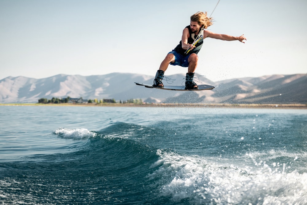 a man jumping on a wakeboard