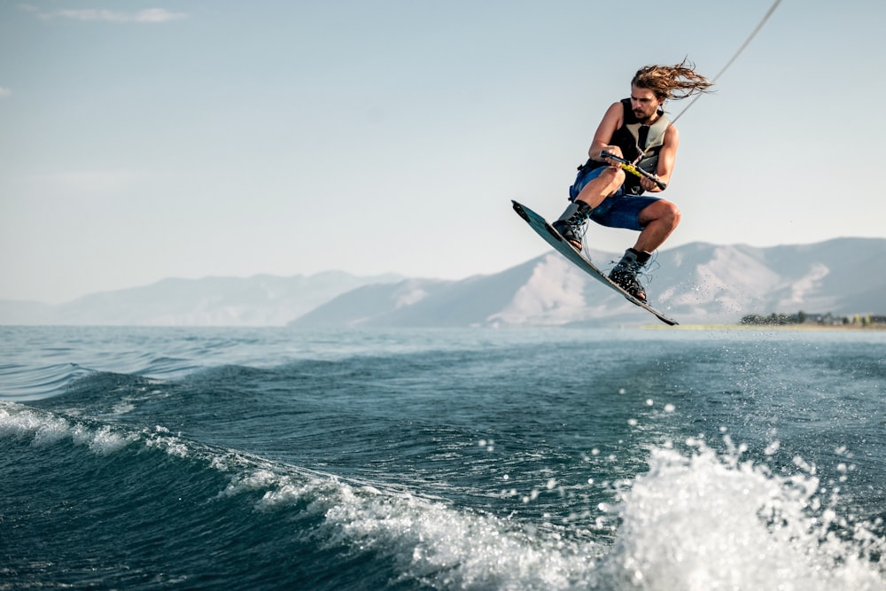 a person parasailing on a wake board