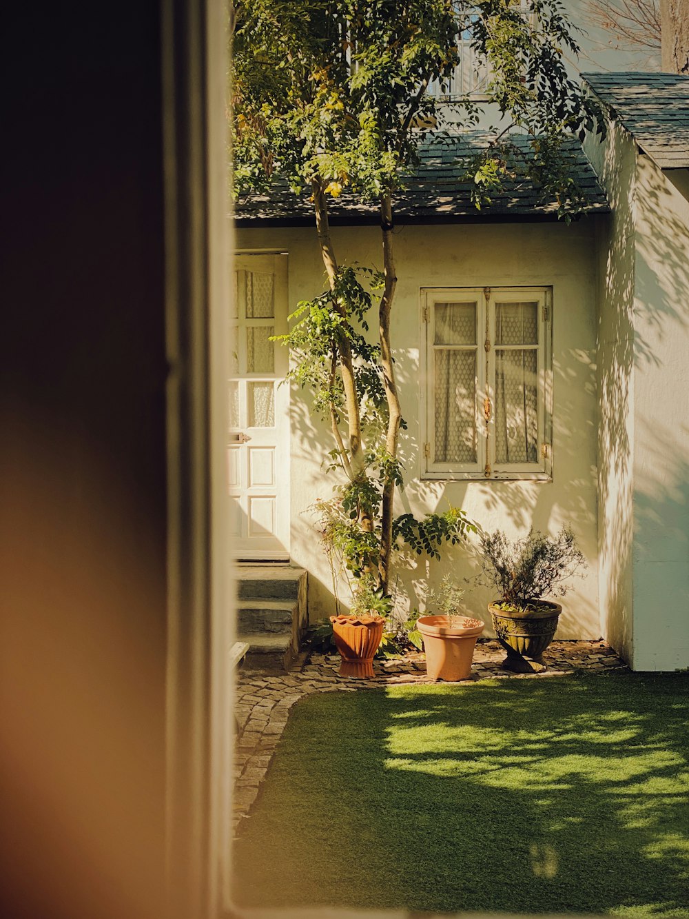 a small house with a green yard