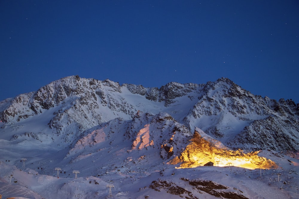 a snowy mountain with a fire in the middle