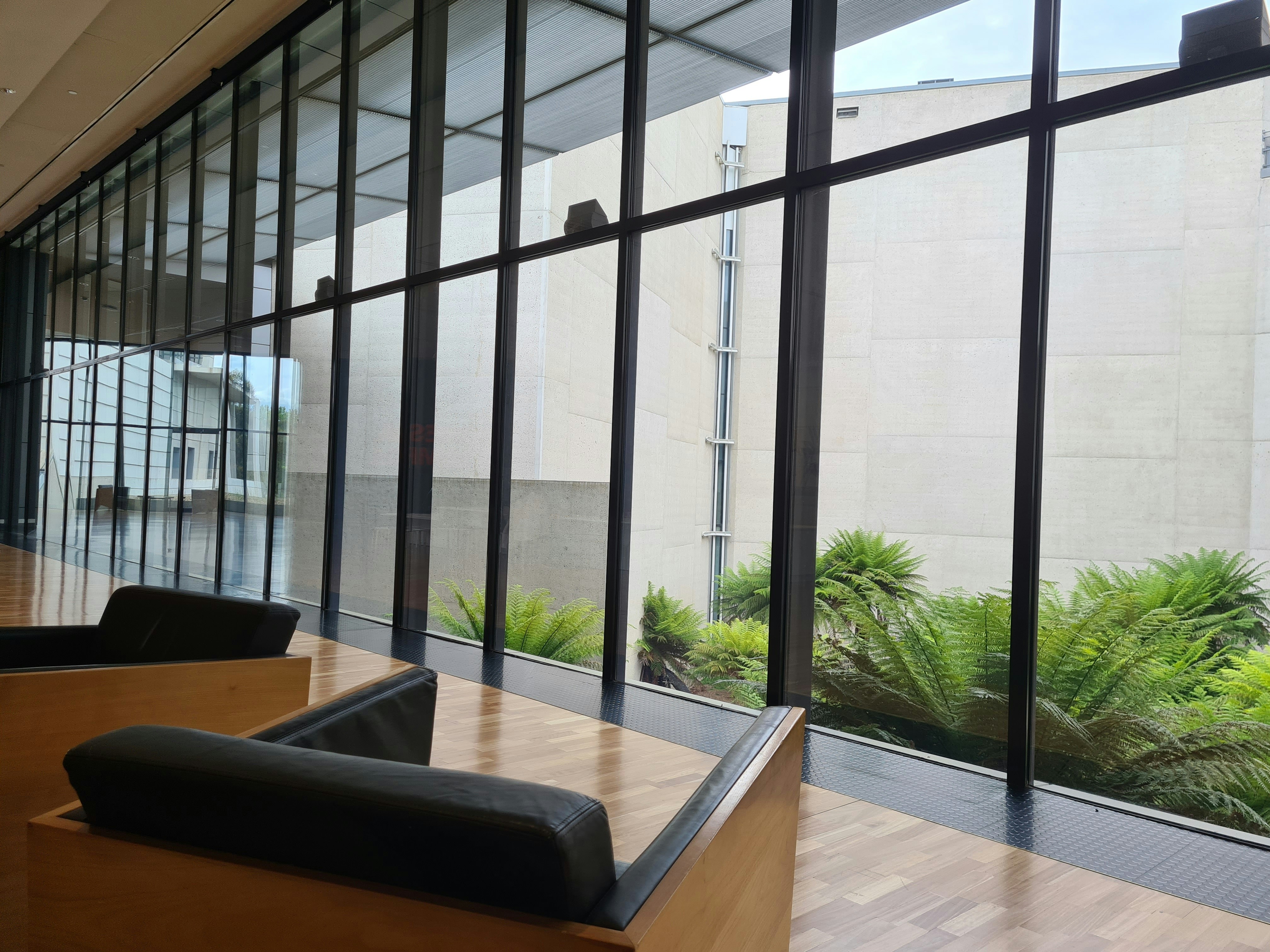 A serene, structured common area in a rehab facility, with comfortable seating and natural light, indicating a conducive environment for healing and recovery. - 6 month inpatient drug rehab dual diagnosis programs near me