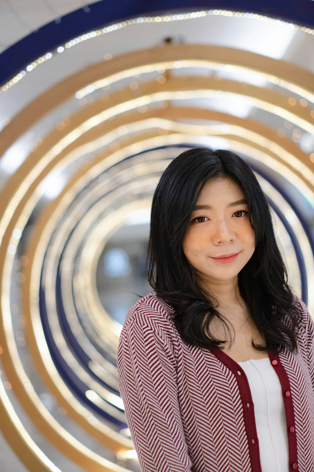 a woman smiling in front of a colorful dome