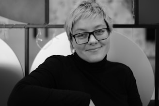 A professional headshot of another diverse team member in a circular frame.