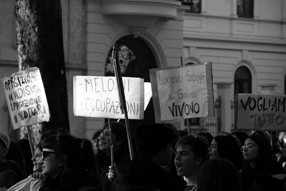 a group of people holding signs