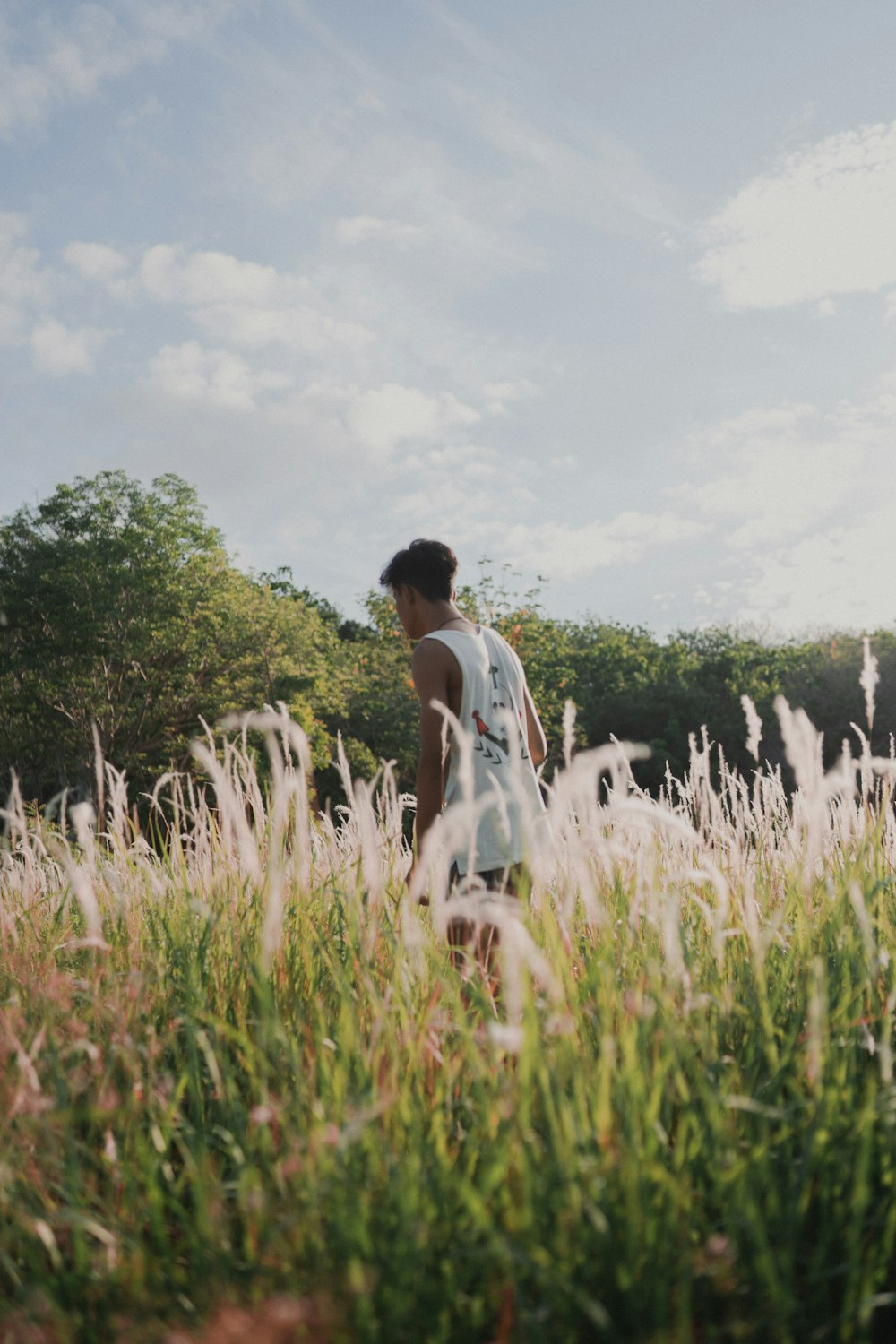 a man standing in a field of tall grass