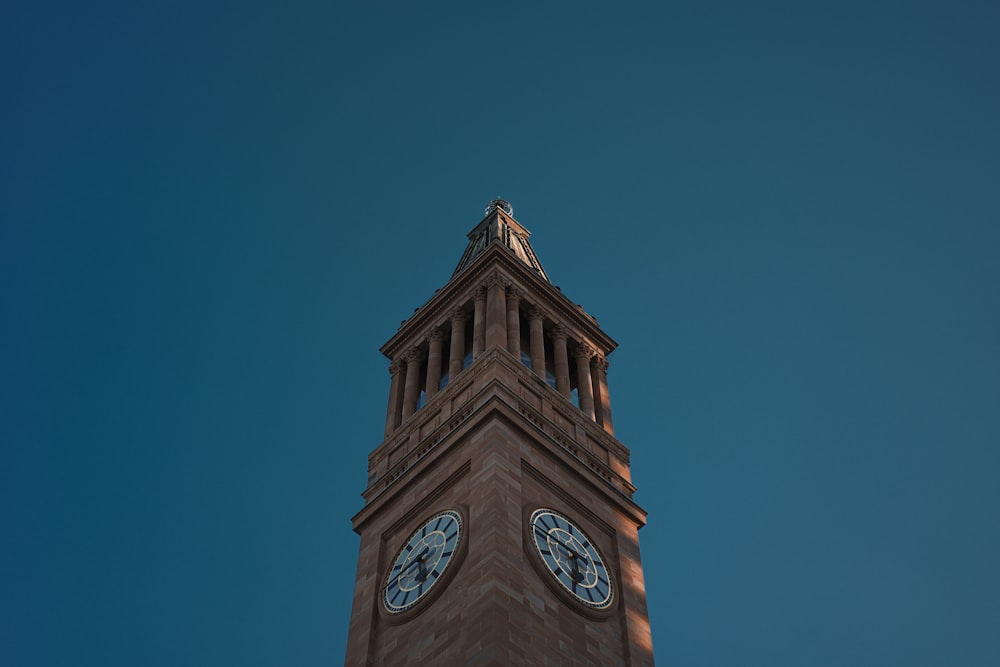 a clock tower with a weather vane