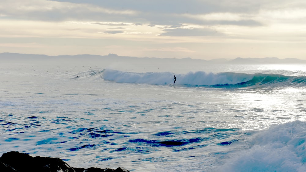 a person surfing on the waves