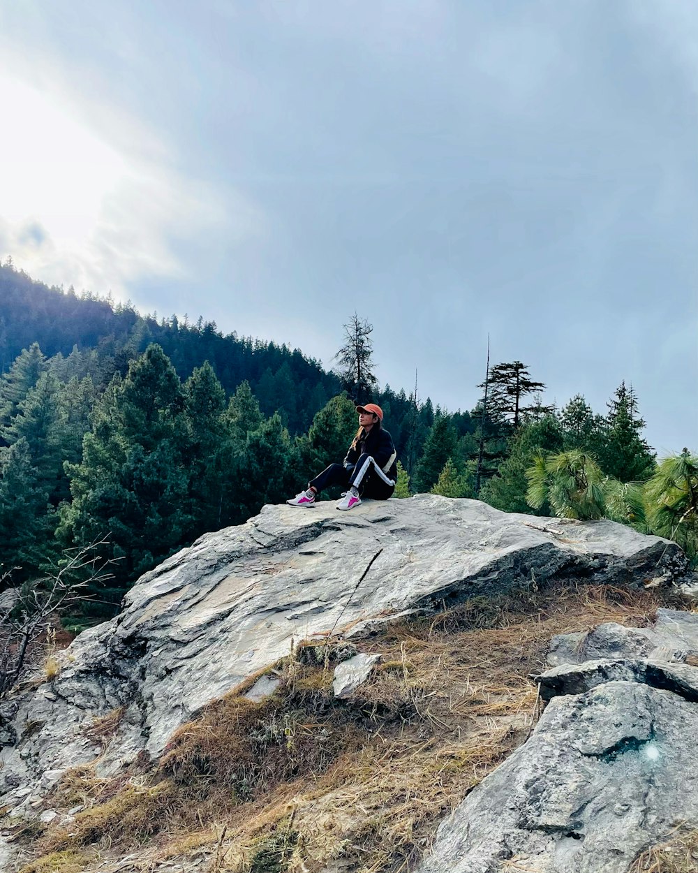 a person sitting on a rock