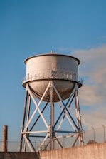 a water tower with a fence around it