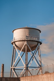 a water tower with a fence around it