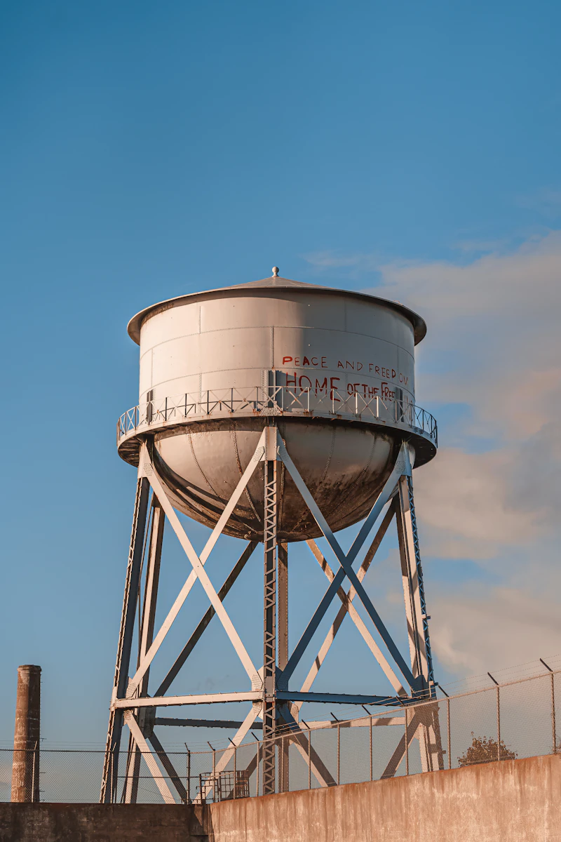 Elevated water tower with surrounding safety fence