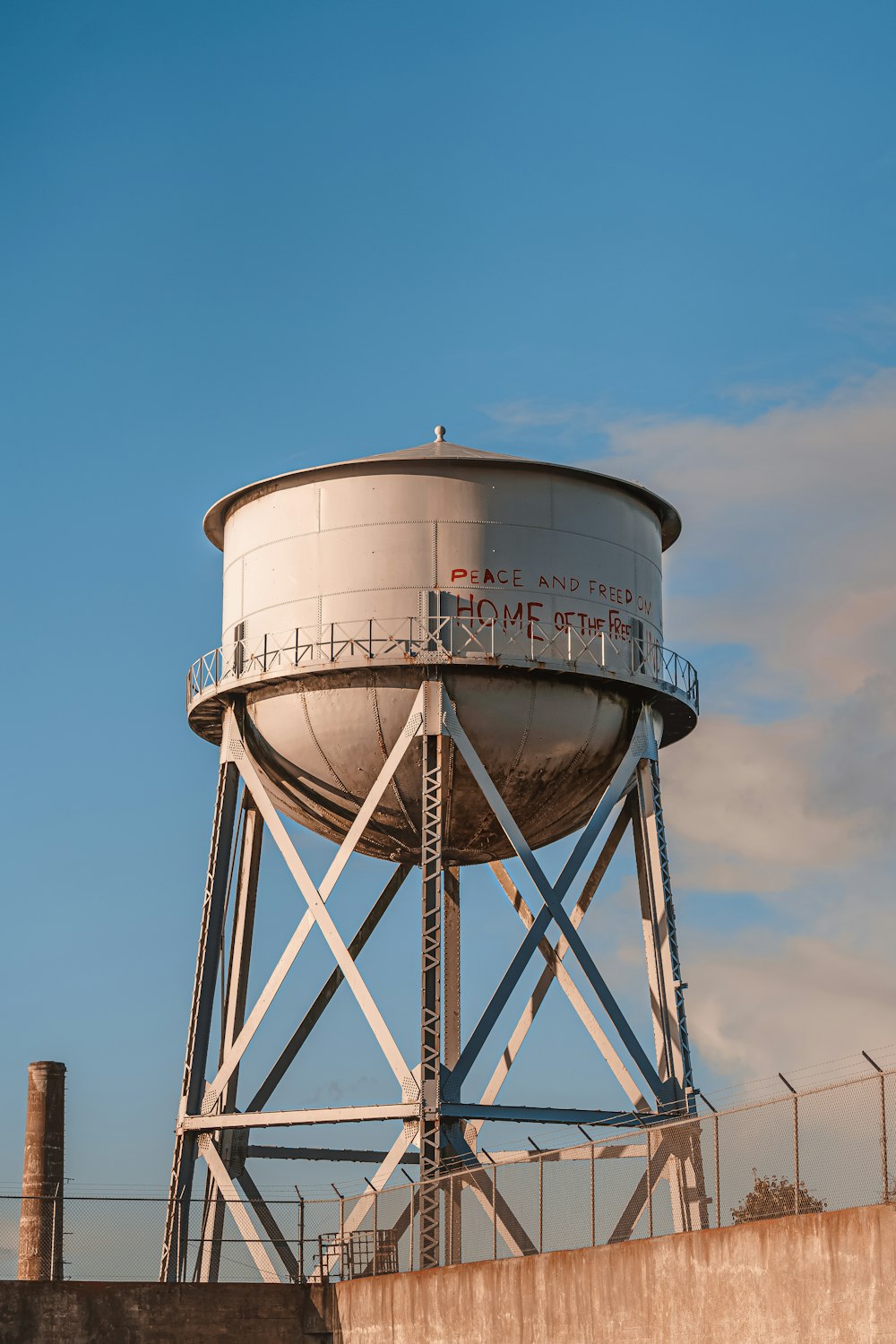 a water tower with a fence around it