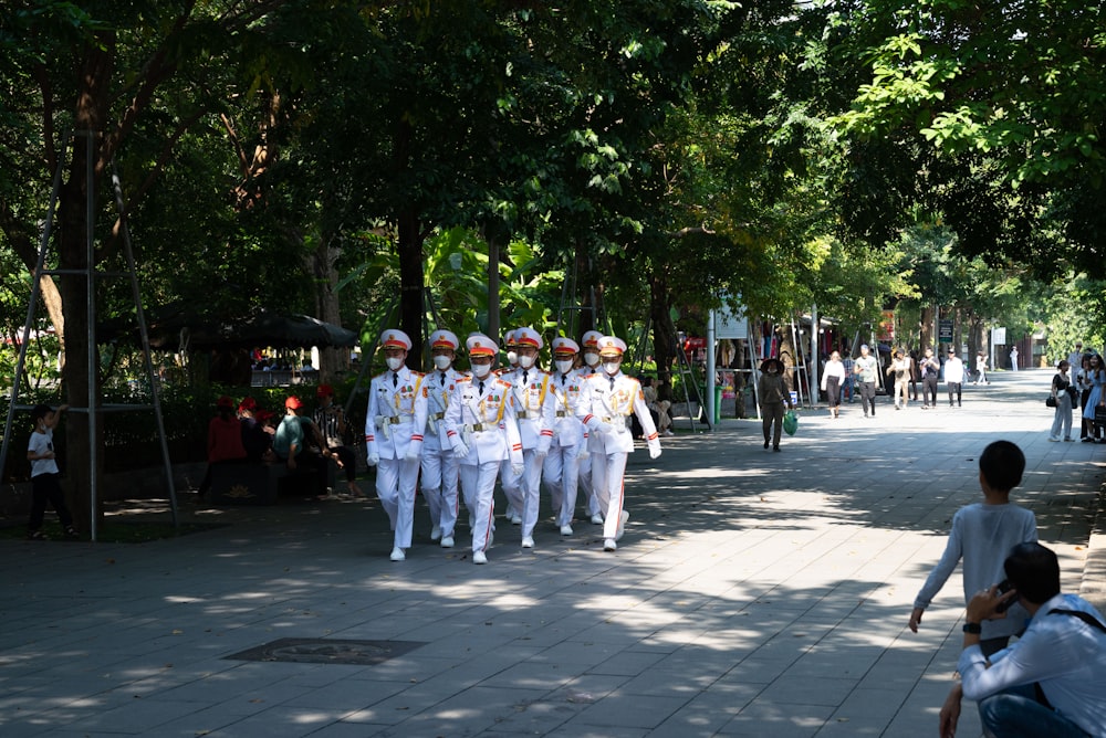 a group of people in white outfits
