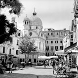 A group of travelers enjoying a guided tour through a charming European old town square.
