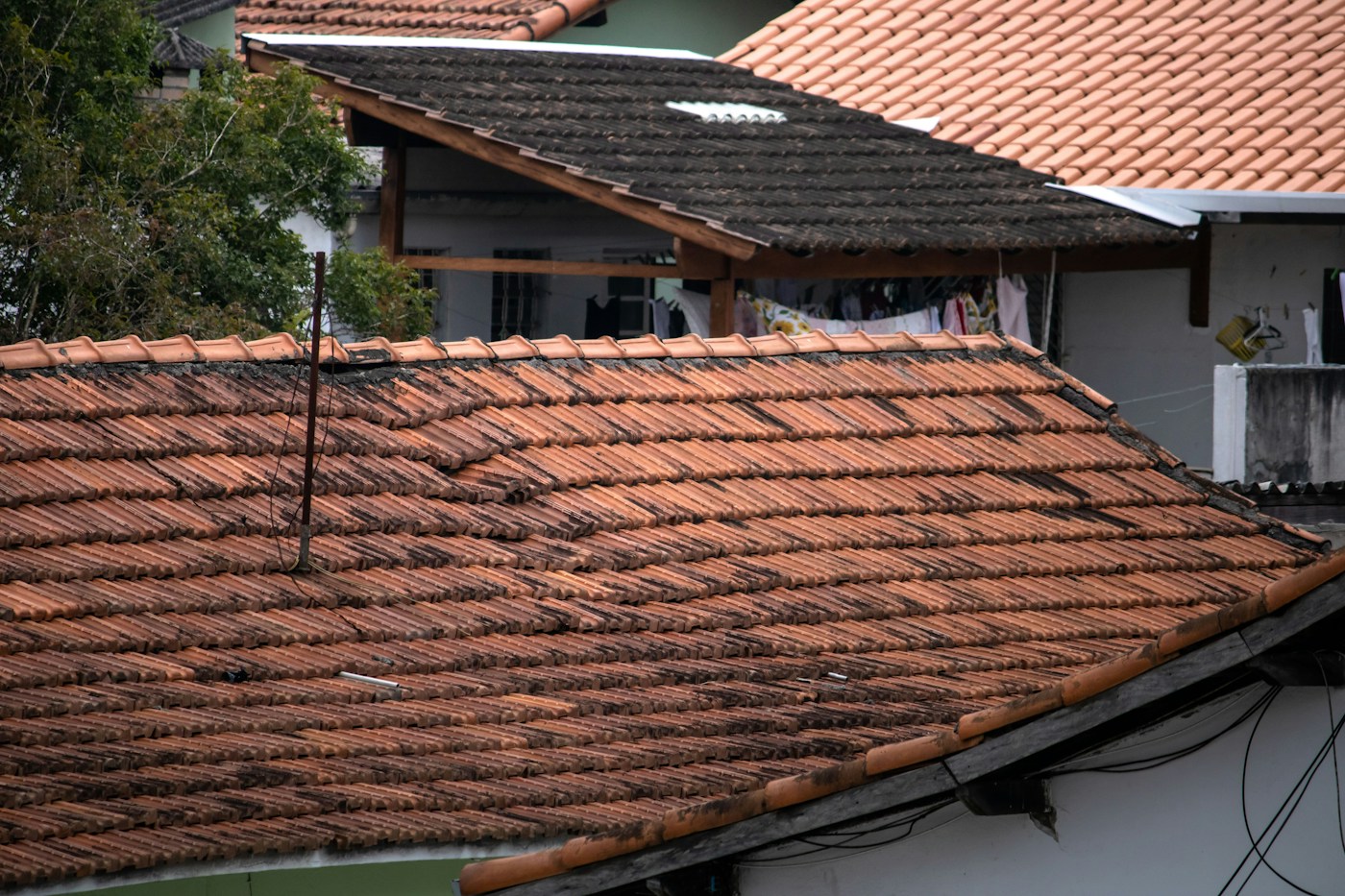 Roof with damaged and missing shingles requiring storm damage repair