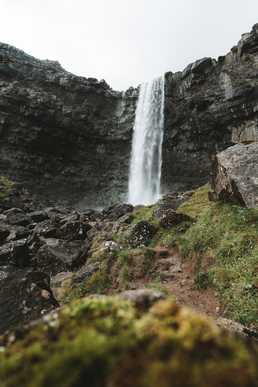 a waterfall over a rocky cliff