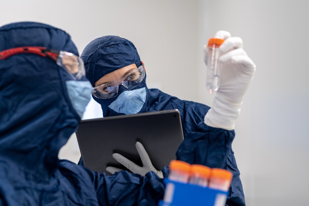 a person in a mask using a laptop