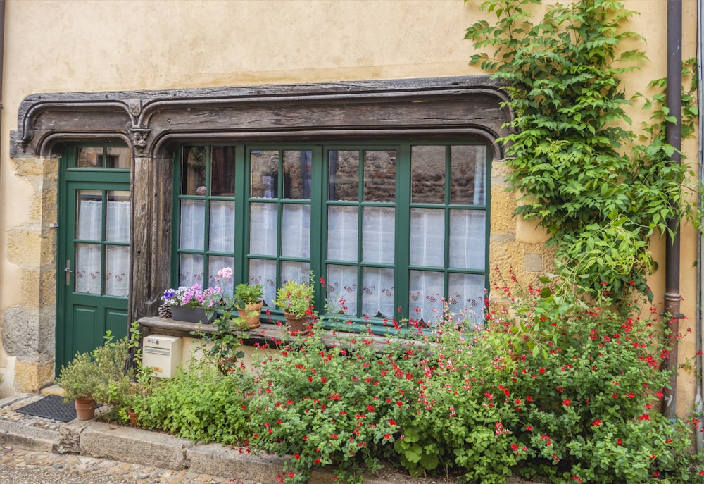 a building with plants and flowers in front of it