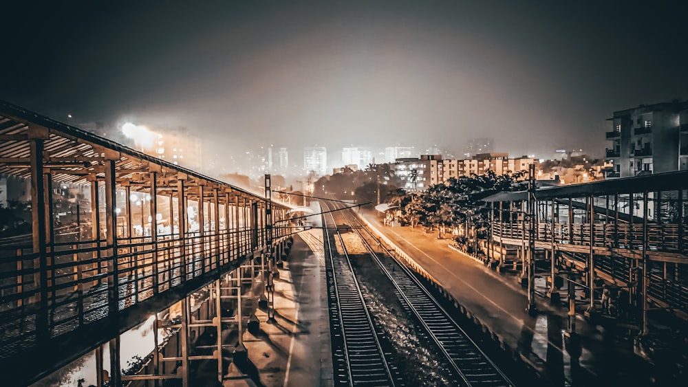 a train track with buildings in the background