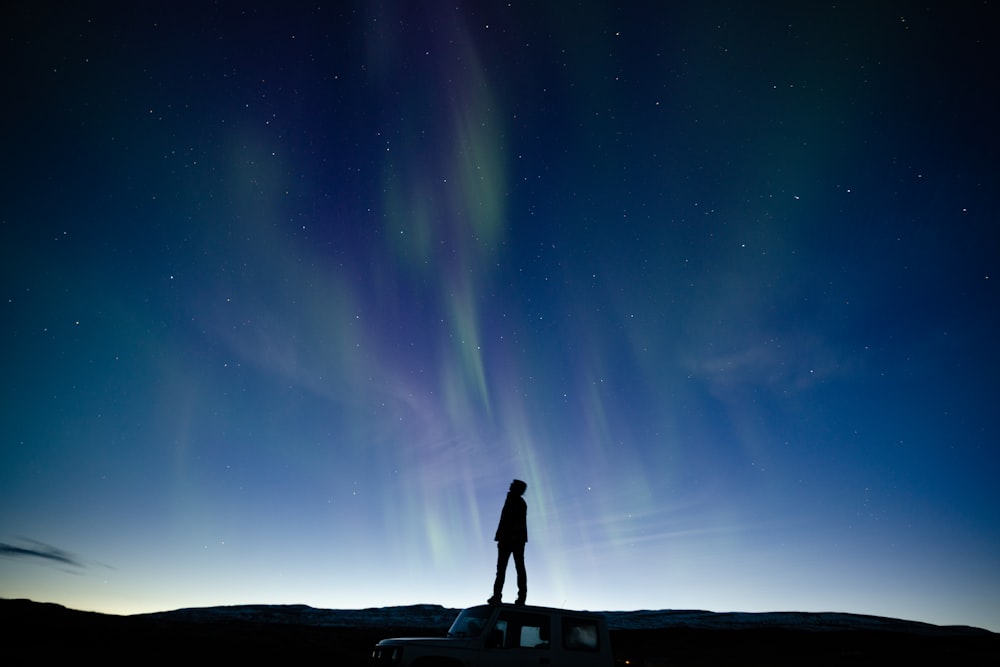 a person standing in front of a starry sky