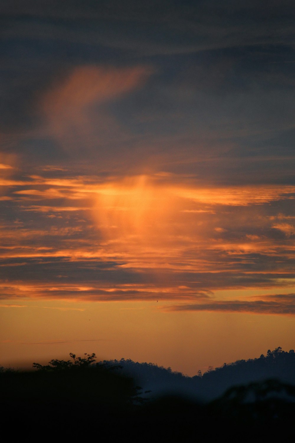 a sunset over a mountain