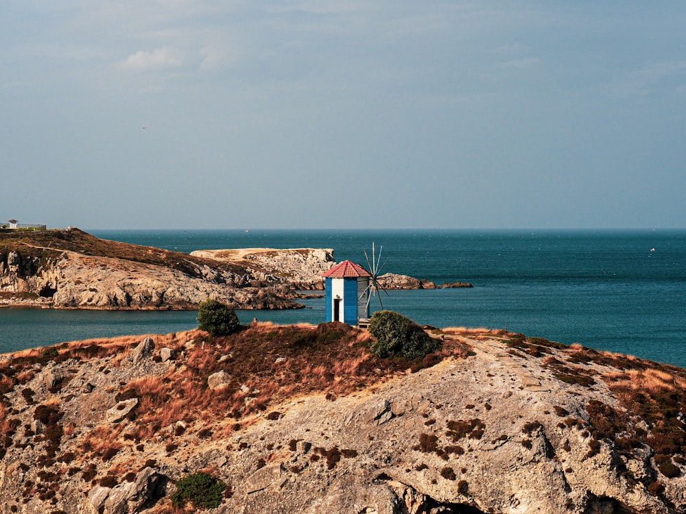 a rocky beach with a small shack