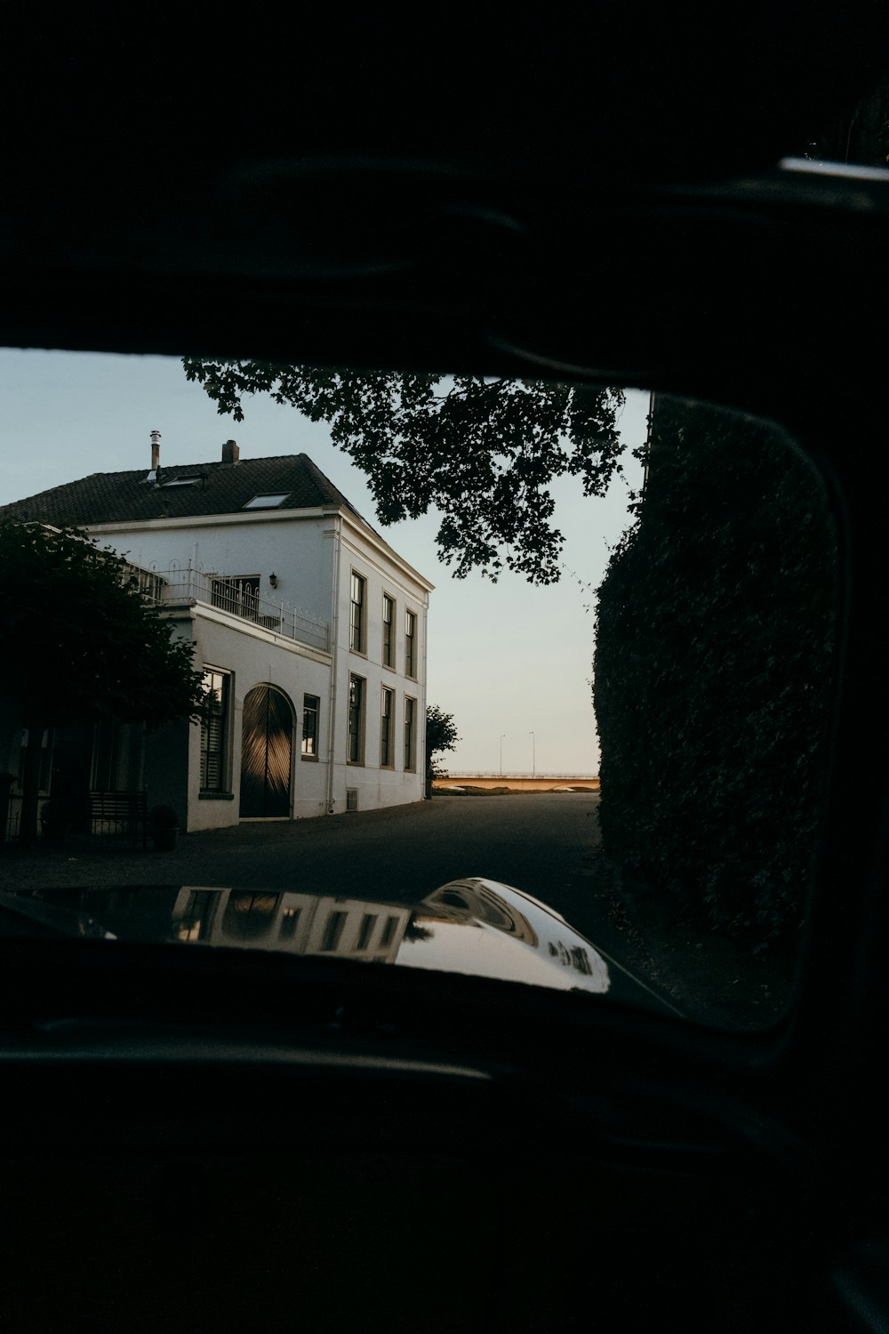 a white building with a black car parked in front of it