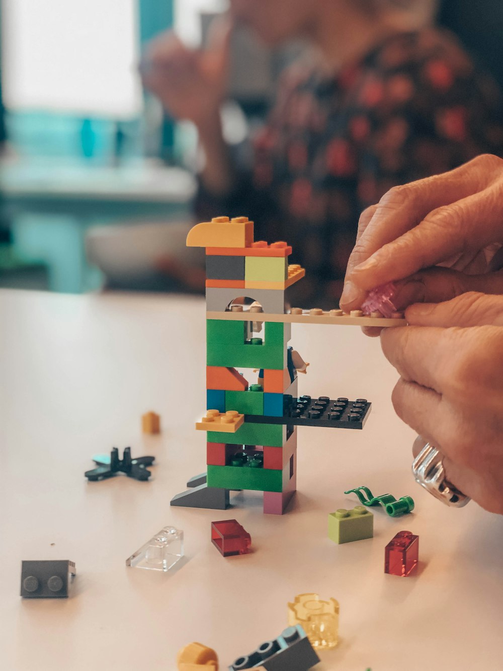 a hand holding a toy building