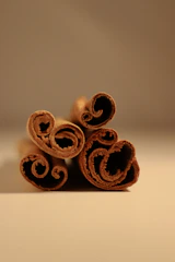 Close-up of aromatic cinnamon sticks arranged in a neat pile.