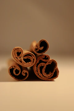 Close-up of aromatic cinnamon sticks arranged in a neat pile.