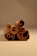 Close-up of rich, curled alba cinnamon sticks resting on rustic wooden surface.