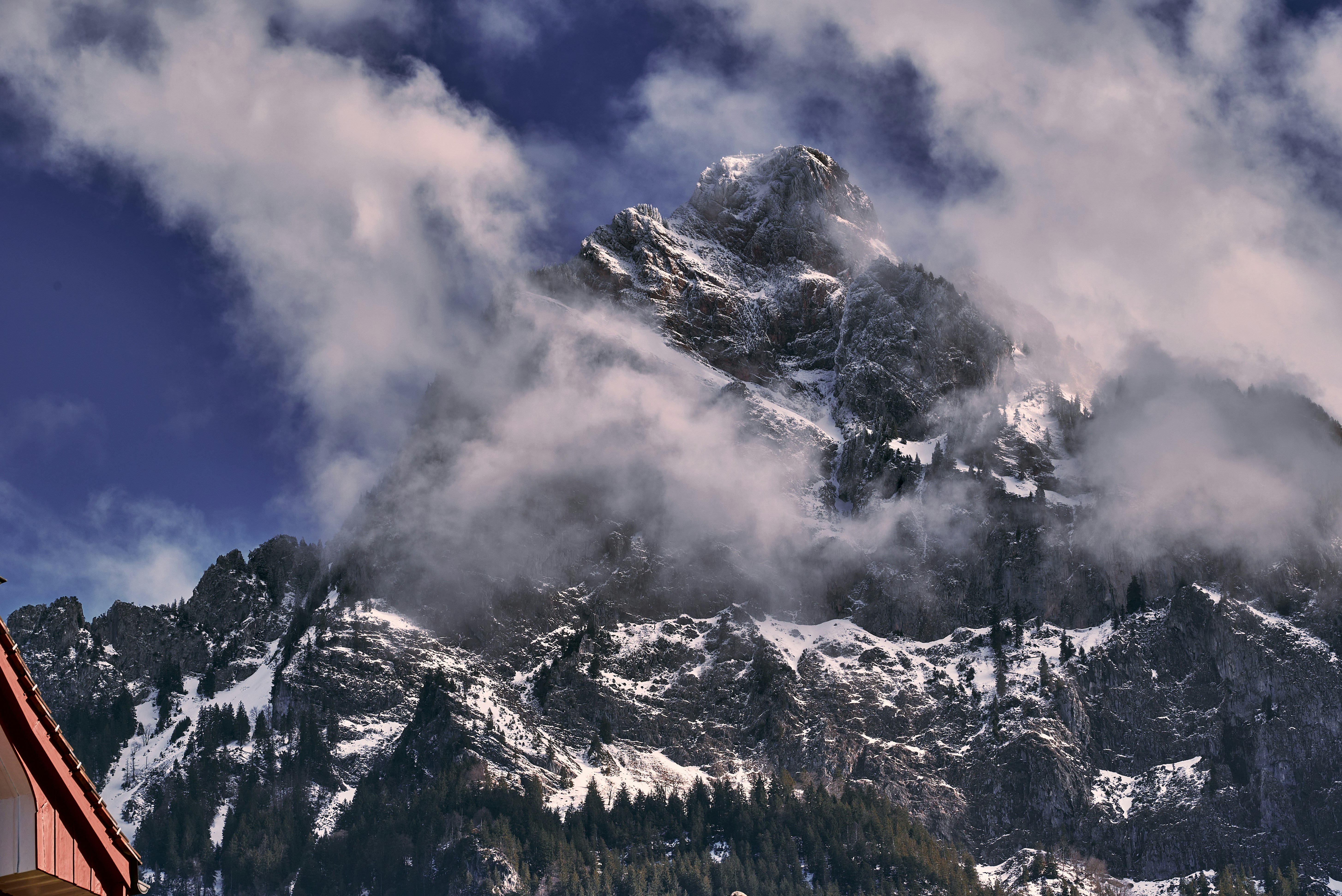 a mountain with clouds, Mountains covered with snow and clouds. Rocks, snowy mountain peaks, Alps, Switzerland