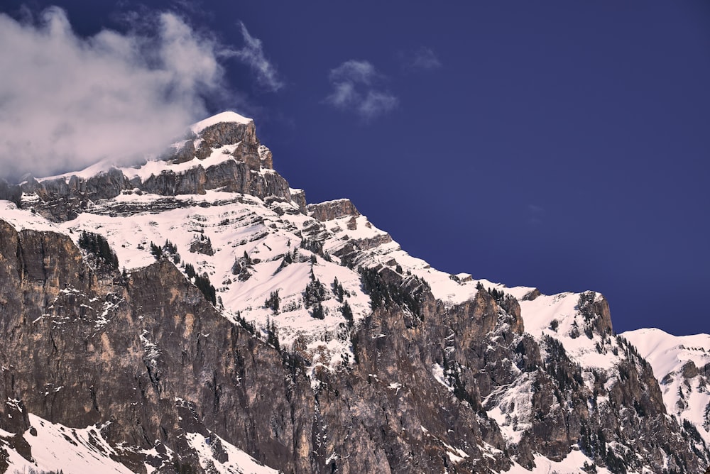 a snowy mountain with a blue sky