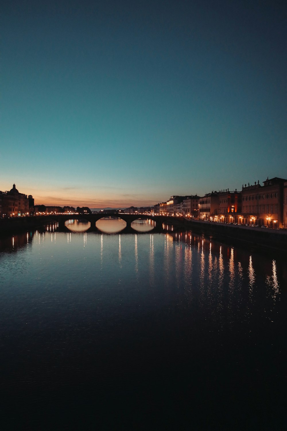 a bridge over a river with buildings on either side of it