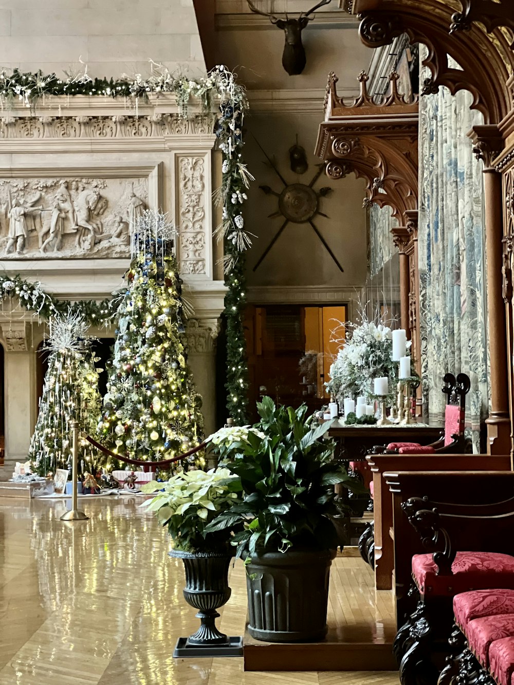 a room with a christmas tree and chairs