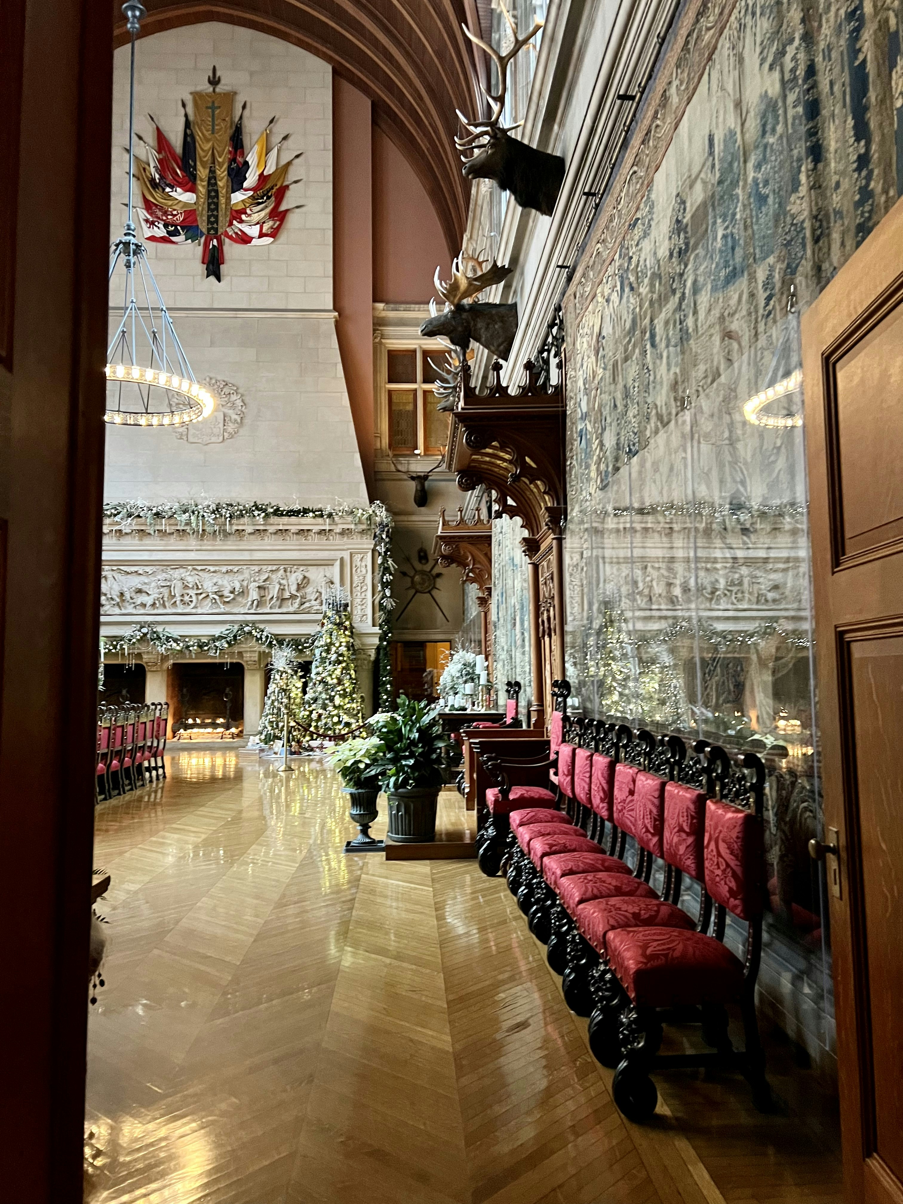 a room with a red couch and chandelier