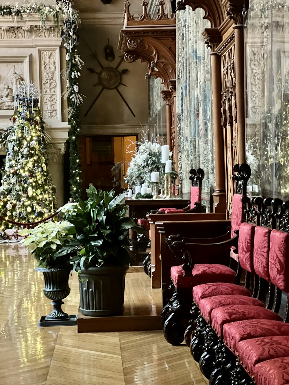 a room with red chairs and a christmas tree