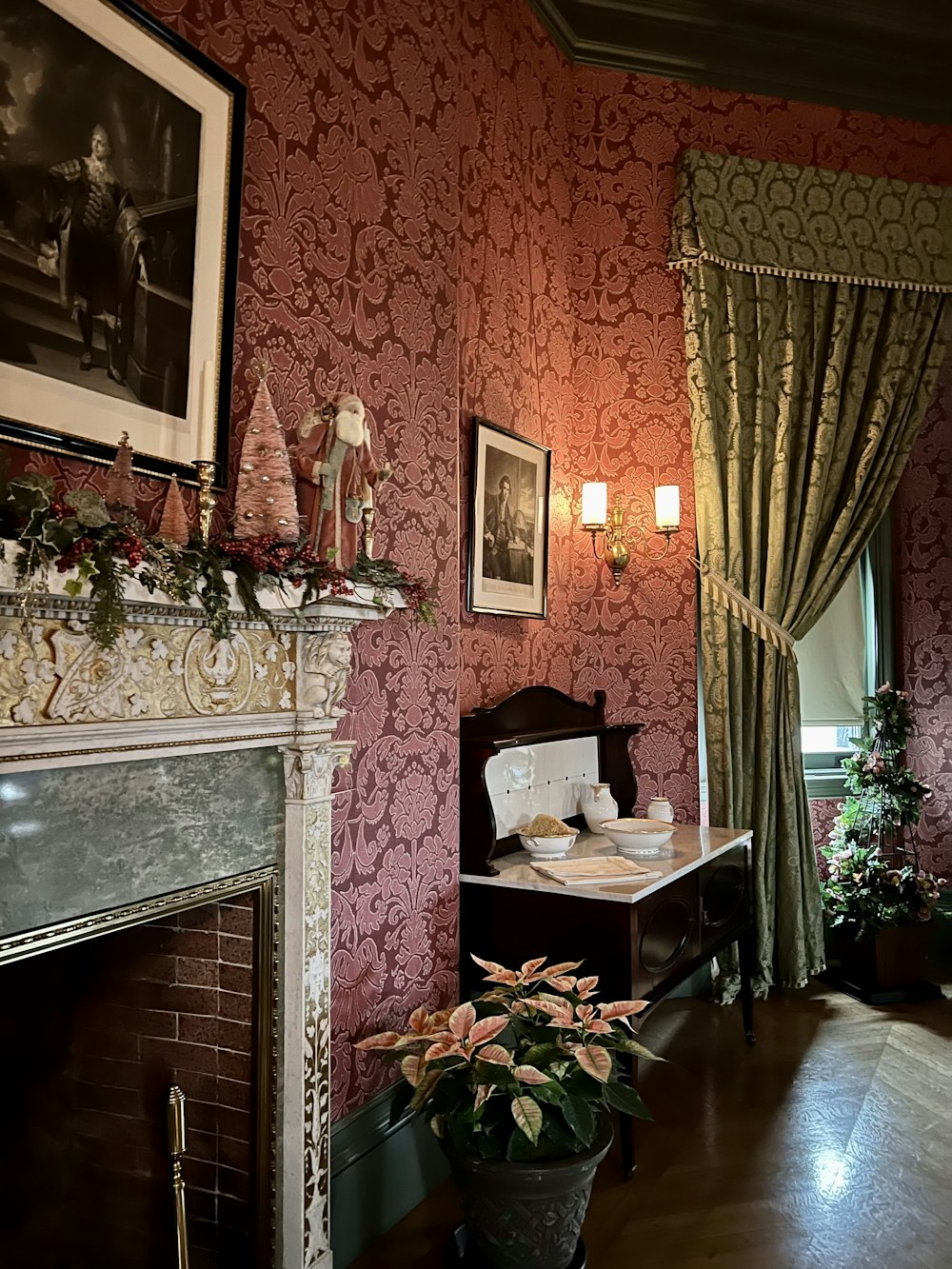 a room with a fireplace and a table with a plant in it