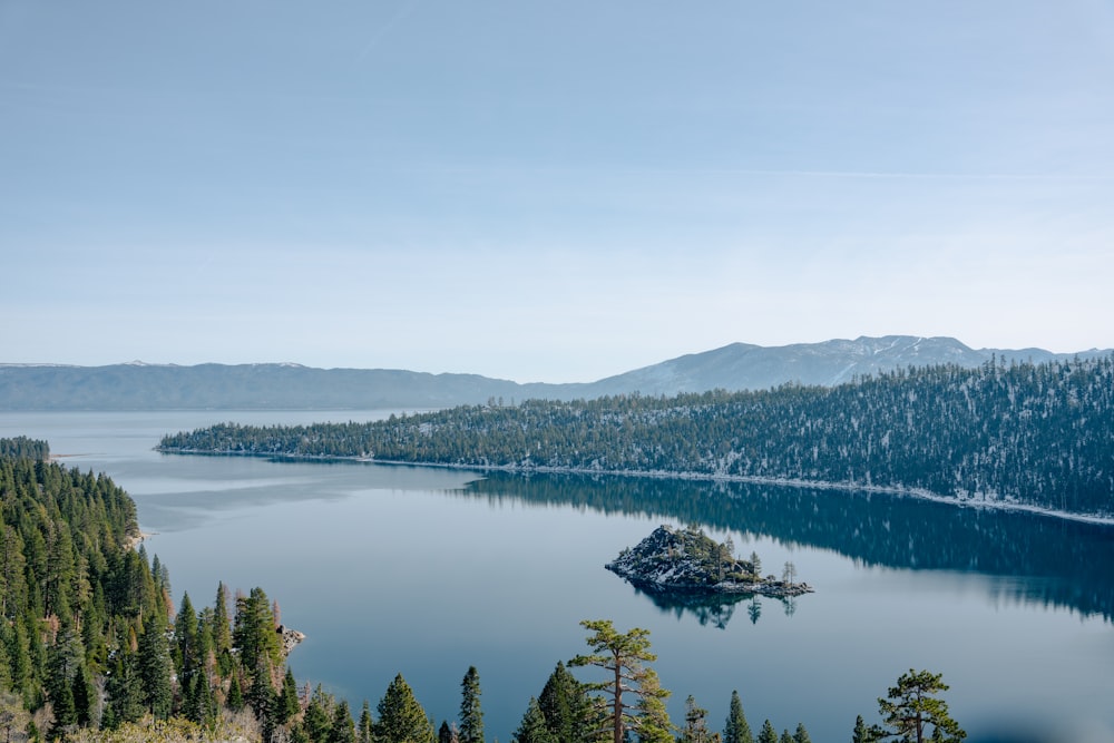 a lake surrounded by trees and mountains