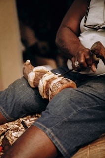 a man cutting a loaf of bread