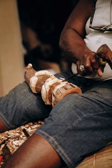 a man cutting a loaf of bread