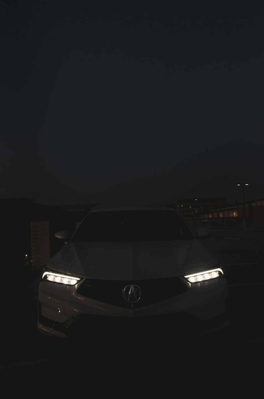 a car parked in a parking lot at night