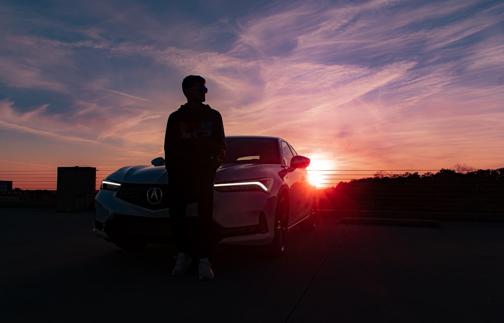 a man standing next to a car