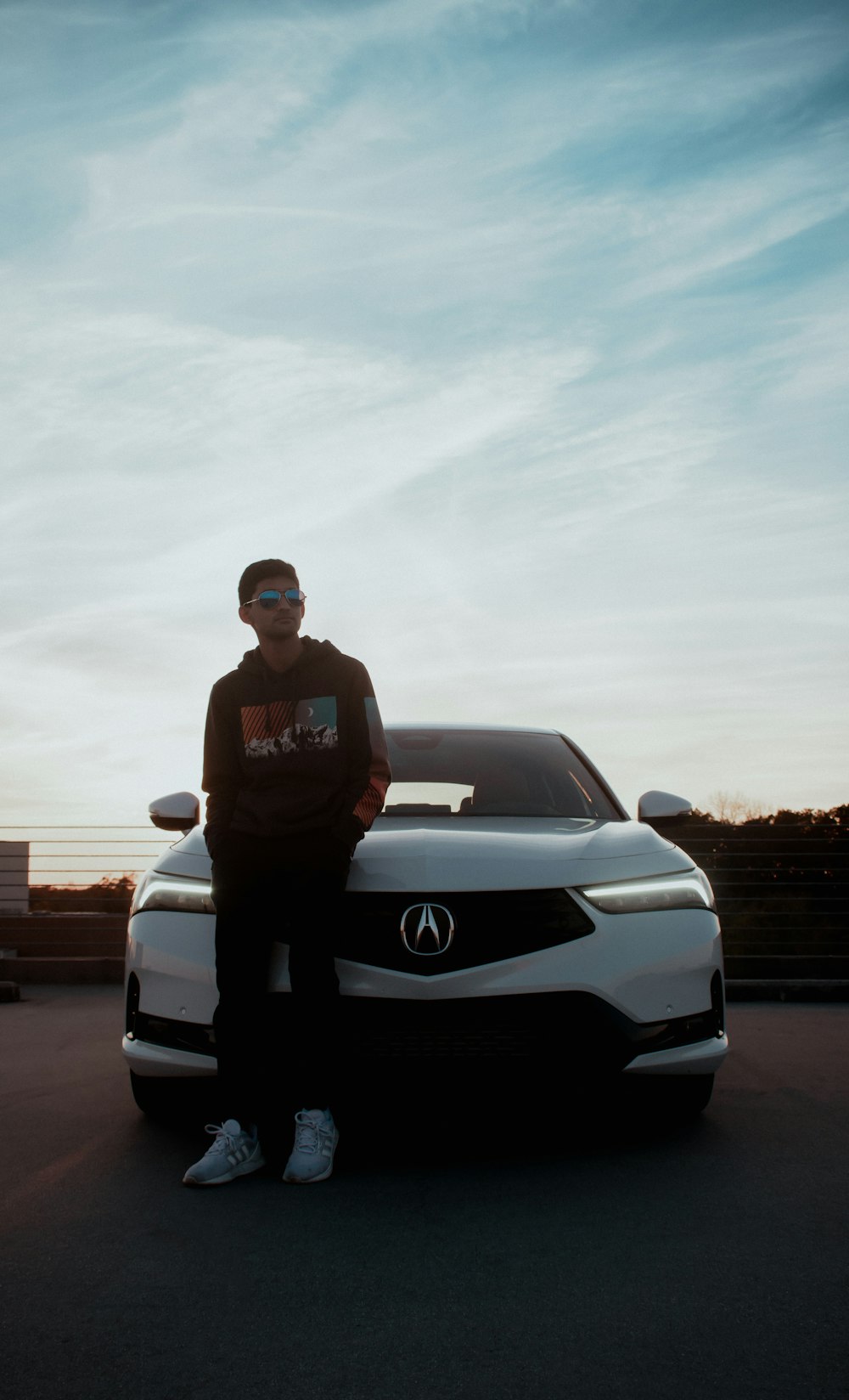 a man standing next to a car